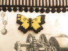 Bouton gros papillon noir et ocre jaune