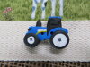 Bouton tracteur bleu New Hollande